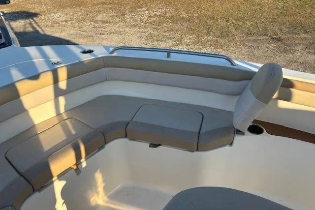 Slide: The Image of 2022 Scout 215 XSF boat interior with cushioned seating and cup holders. - 11