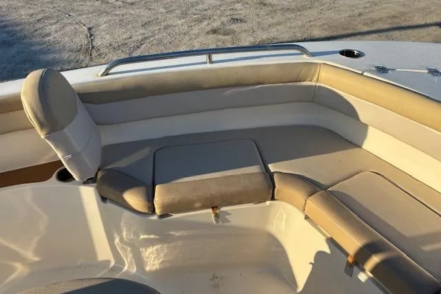 Slide: The Image of 2022 Scout 215 XSF boat interior with cushioned seating and railings. - 12