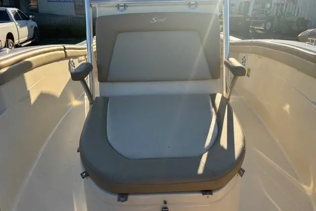 Slide: The Image of 2022 Scout 215 XSF boat interior with cushioned seating and armrests. - 13