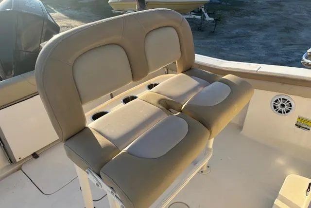Slide: The Image of 2022 Scout 215 XSF boat seating with beige cushions and cup holders. - 16