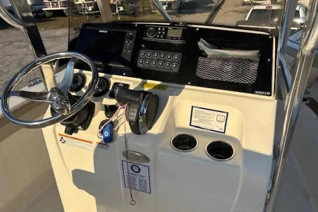 Slide: The Image of 2022 Scout 215 XSF boat dashboard with steering wheel and control panel. - 19