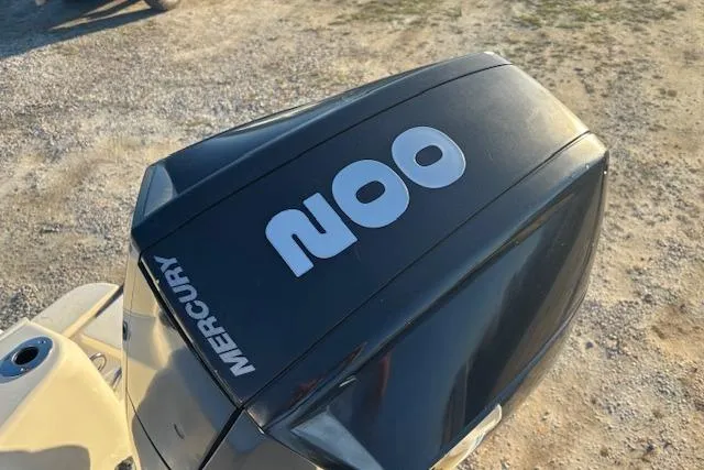 Slide: The Image of Mercury 200 outboard engine on 2022 Scout 215 XSF boat, parked on gravel. - 23