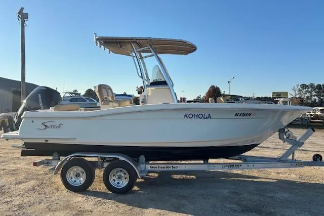 Slide: The Image of 2022 Scout 215 XSF boat on trailer, side view, outdoors. - 8