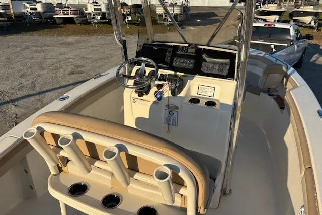 Slide: The Image of 2022 Scout 215 XSF boat interior with steering console and rod holders. - 9