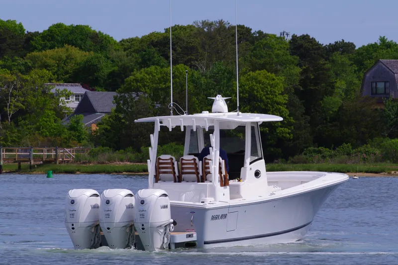 Slide: The Image of 2025 Regulator 35 boat with triple engines on a calm lake. - 10