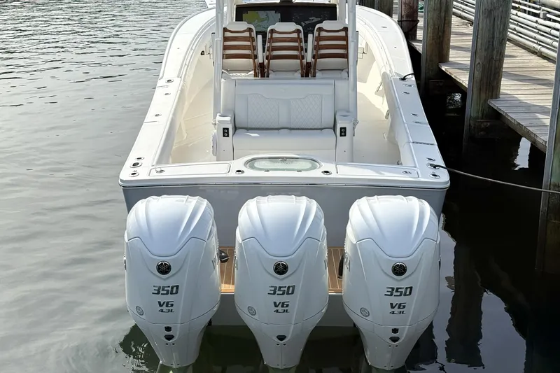Slide: The Image of 2025 Regulator 35 boat with triple 350 V6 engines docked at a marina. - 13