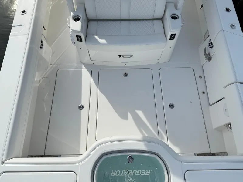 Slide: The Image of 2025 Regulator 35 boat interior with white seating and storage compartments. - 20