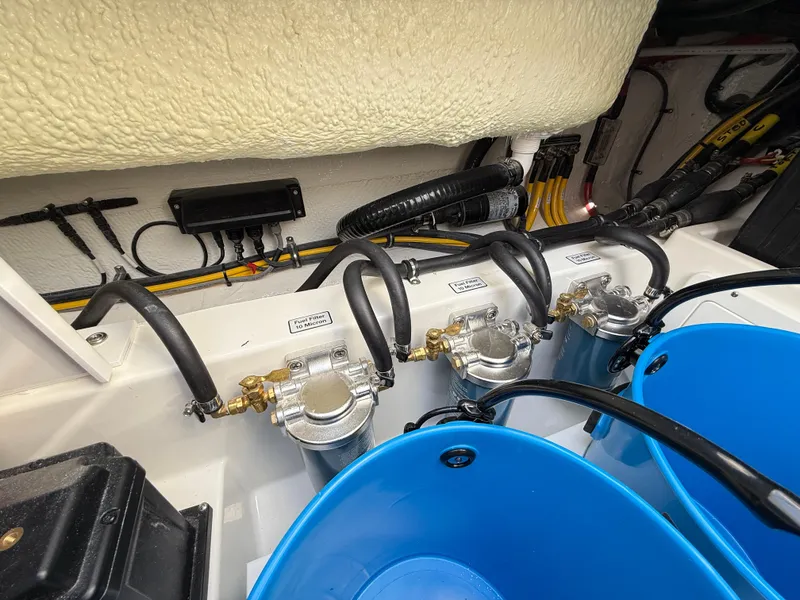 Slide: The Image of 2025 Regulator 35 boat engine compartment with fuel filters and blue buckets. - 23