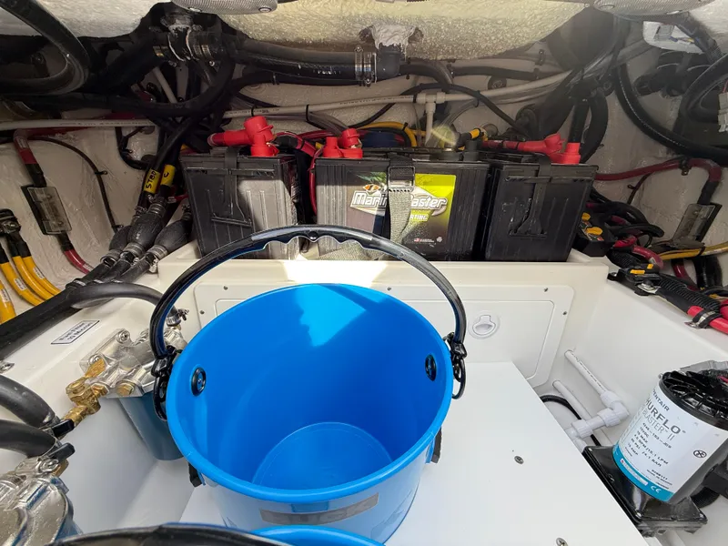Slide: The Image of 2025 Regulator 35 boat engine compartment with batteries and blue bucket. - 24