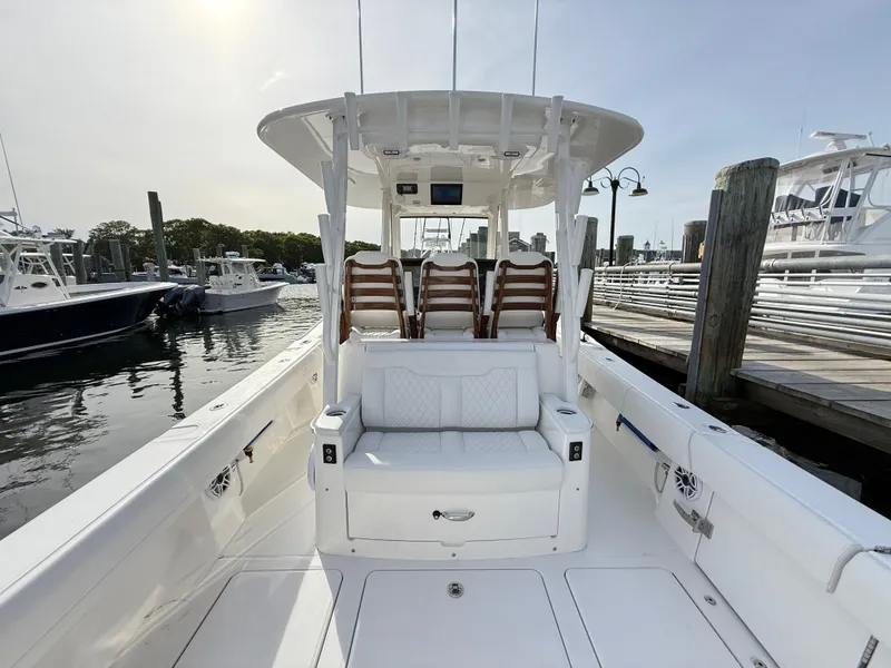 Slide: The Image of 2025 Regulator 35 boat docked, featuring spacious seating and sleek design. - 27
