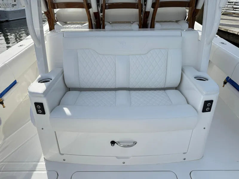 Slide: The Image of White leather seating on 2025 Regulator 35 boat, featuring cup holders and quilted design. - 28
