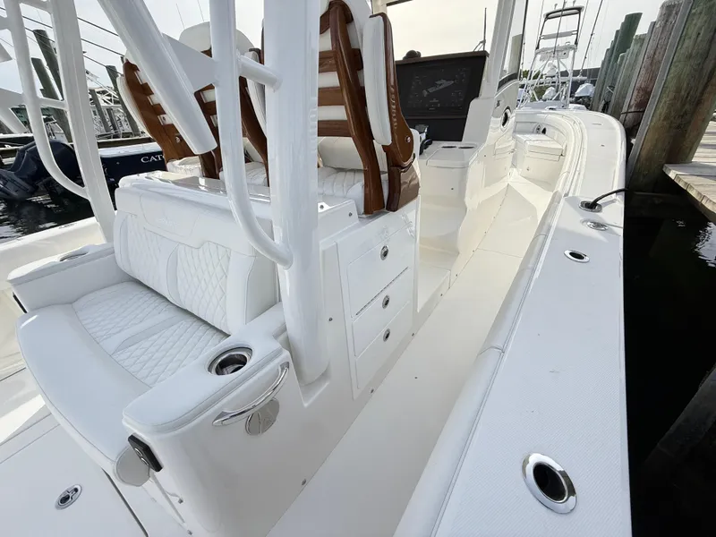Slide: The Image of 2025 Regulator 35 boat interior with white seating and storage compartments. - 40