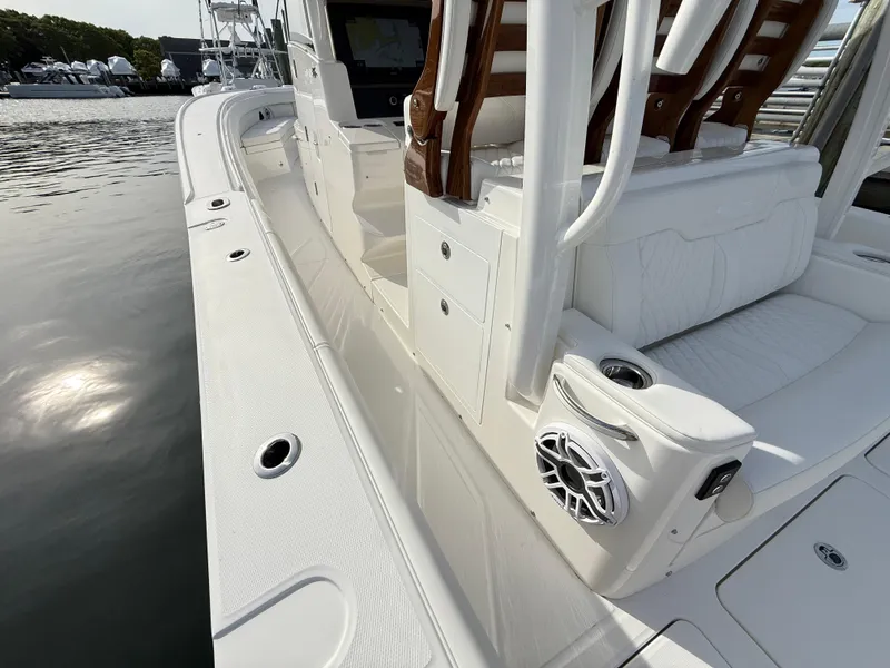 Slide: The Image of 2025 Regulator 35 boat with sleek white deck and seating, docked by the water. - 42