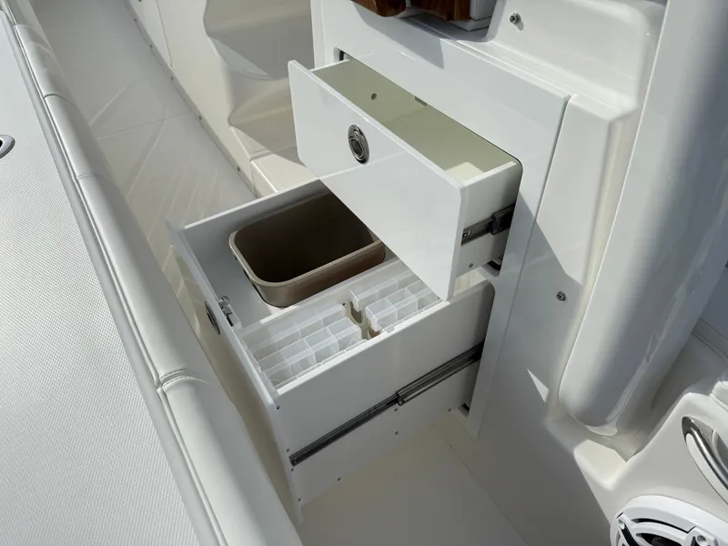 Slide: The Image of 2025 Regulator 35 boat storage compartments with open drawers and organizer. - 43