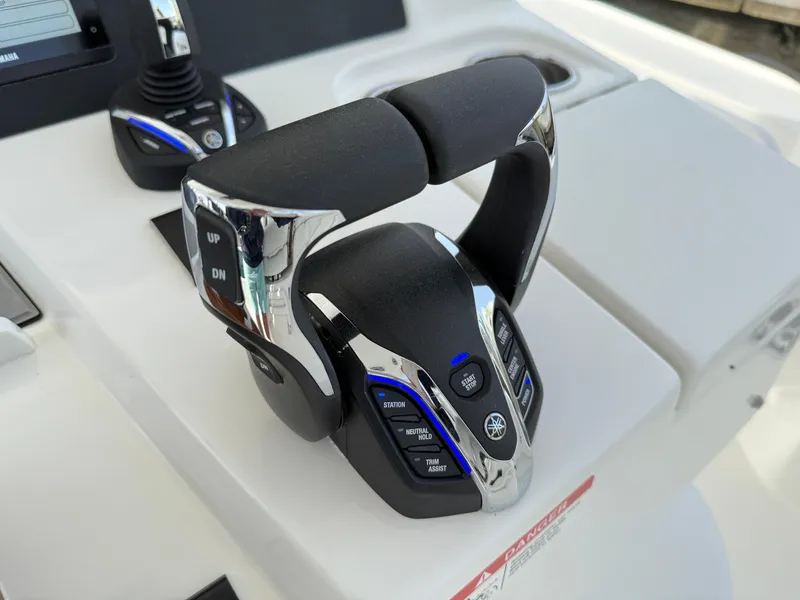 Slide: The Image of 2025 Regulator 35 boat throttle control with chrome and black finish. - 49
