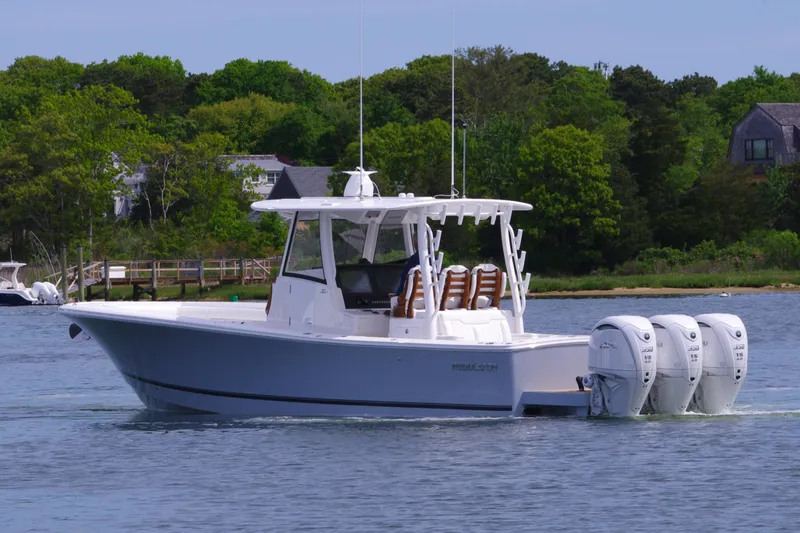 Slide: The Image of 2025 Regulator 35 boat with triple engines on a calm lake. - 7