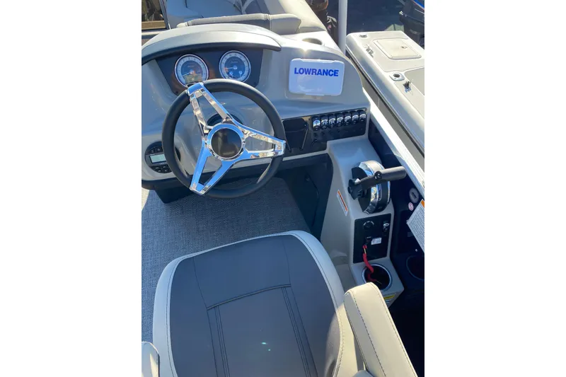 Slide: The Image of 2022 Barletta Cabrio 22UC boat dashboard with steering wheel and Lowrance device. - 10