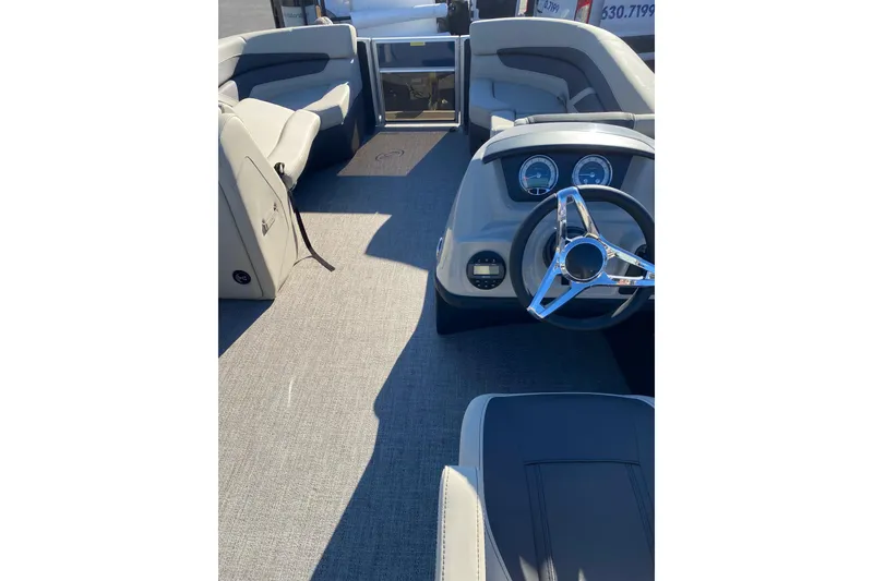 Slide: The Image of 2022 Barletta Cabrio 22UC boat interior with steering wheel and seating. - 11