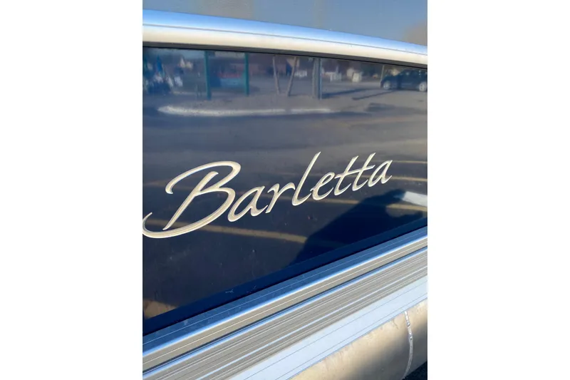Slide: The Image of Barletta Cabrio 22UC 2022 model nameplate on a sleek boat exterior. - 15