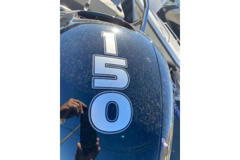 Slide: The Image of Close-up of a 150 horsepower engine on a 2022 Barletta Cabrio 22UC boat. - 20