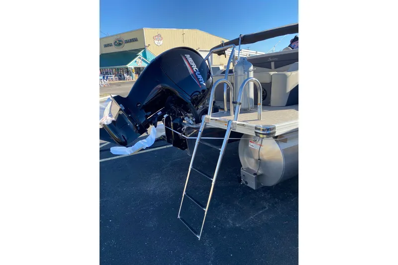 Slide: The Image of 2022 Barletta Cabrio 22UC pontoon boat with Mercury outboard motor and boarding ladder. - 23