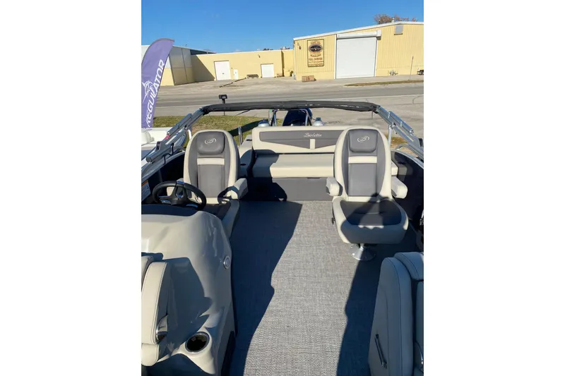 Slide: The Image of 2022 Barletta Cabrio 22UC pontoon boat interior with gray seating and steering wheel. - 8