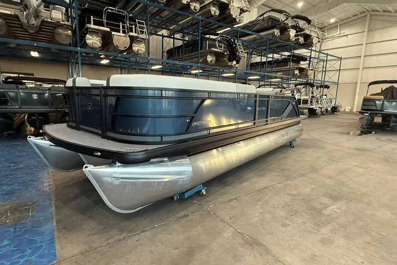 The Image of 2026 Godfrey SWEETWATER 2286 SB pontoon boat in a showroom setting. - 0