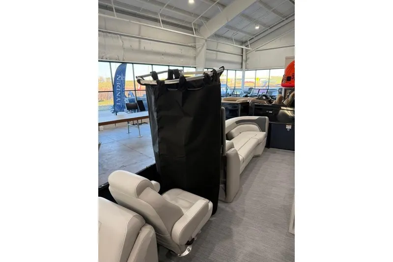 Slide: The Image of 2026 Godfrey SWEETWATER 2286 SB interior with seating and privacy curtain in showroom. - 16