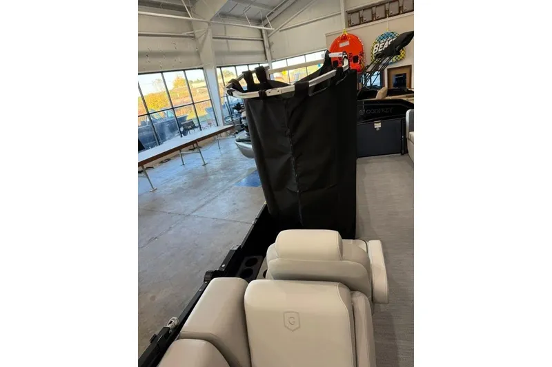 Slide: The Image of 2026 Godfrey SWEETWATER 2286 SB interior with seating and storage cover in showroom. - 17