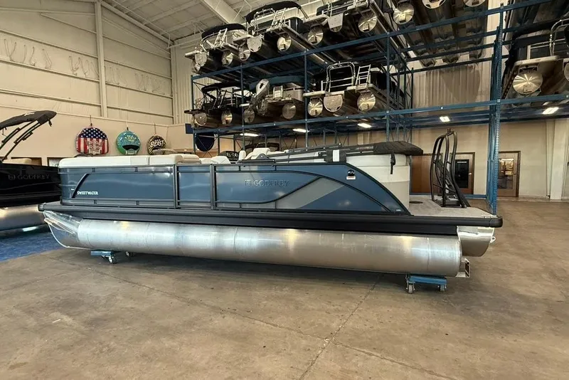 Slide: The Image of 2026 Godfrey SWEETWATER 2286 SB interior with seating and privacy curtain in showroom. - 26
