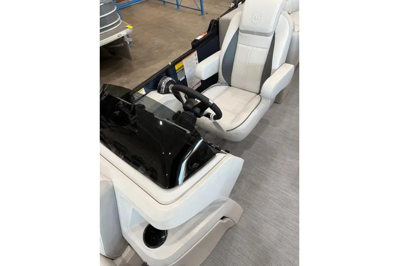 Slide: The Image of 2026 Godfrey SWEETWATER 2286 SB boat interior with steering console and captain's chair. - 7