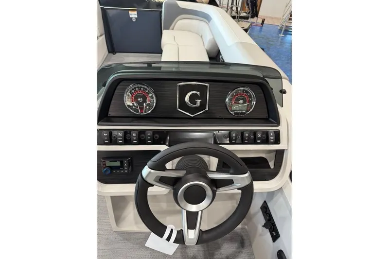 Slide: The Image of 2026 Godfrey SWEETWATER 2286 SB dashboard with steering wheel and control panel. - 9