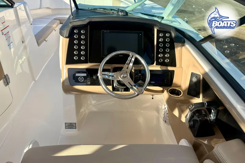Slide: The Image of 2019 Robalo R317 Dual Console boat helm with steering wheel and control panel. - 11