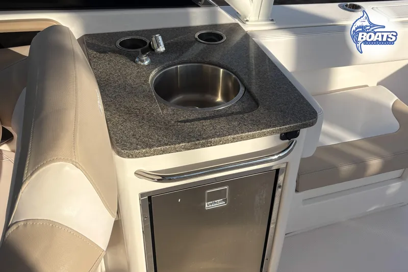 Slide: The Image of 2019 Robalo R317 Dual Console boat interior with sink and mini fridge. - 12