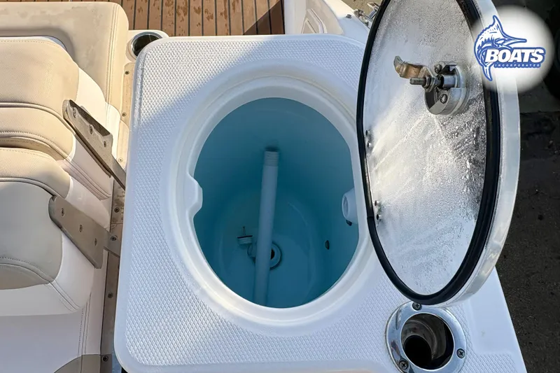 Slide: The Image of 2019 Robalo R317 Dual Console boat livewell with open lid and seating area. - 14