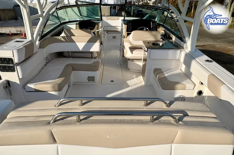 Slide: The Image of 2019 Robalo R317 Dual Console boat interior with beige seating and helm station. - 15