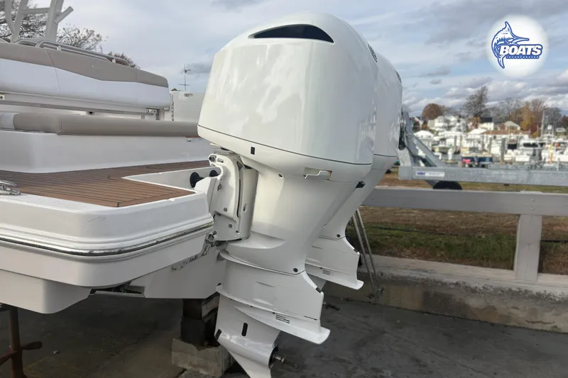 Slide: The Image of 2019 Robalo R317 Dual Console boat with twin outboard engines at marina. - 18