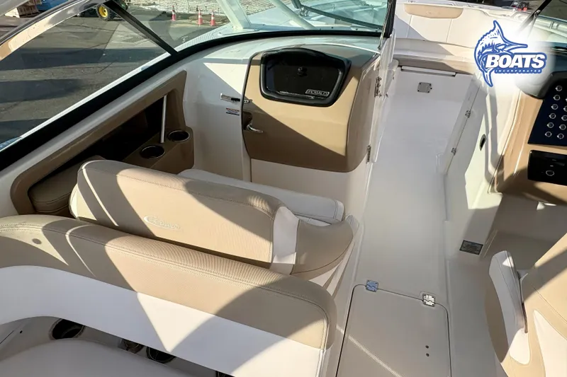 Slide: The Image of 2019 Robalo R317 Dual Console interior with beige seating and dashboard. - 7