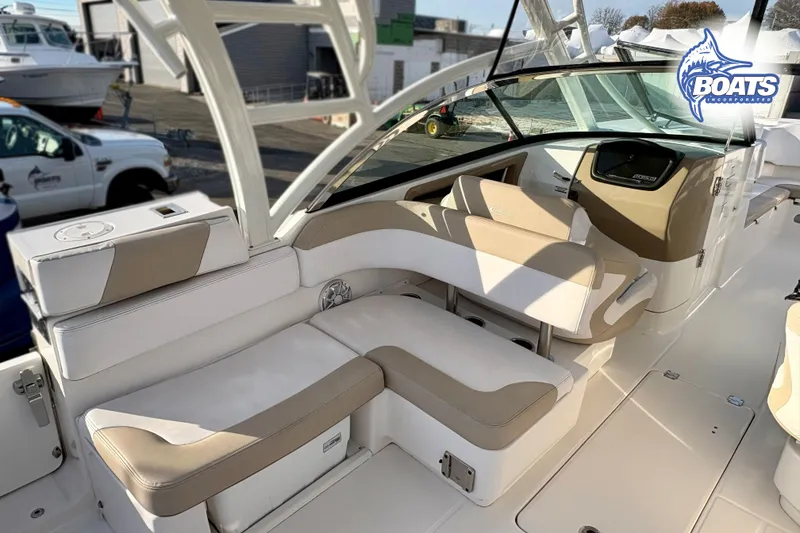 Slide: The Image of 2019 Robalo R317 Dual Console boat interior with beige and white seating. - 9