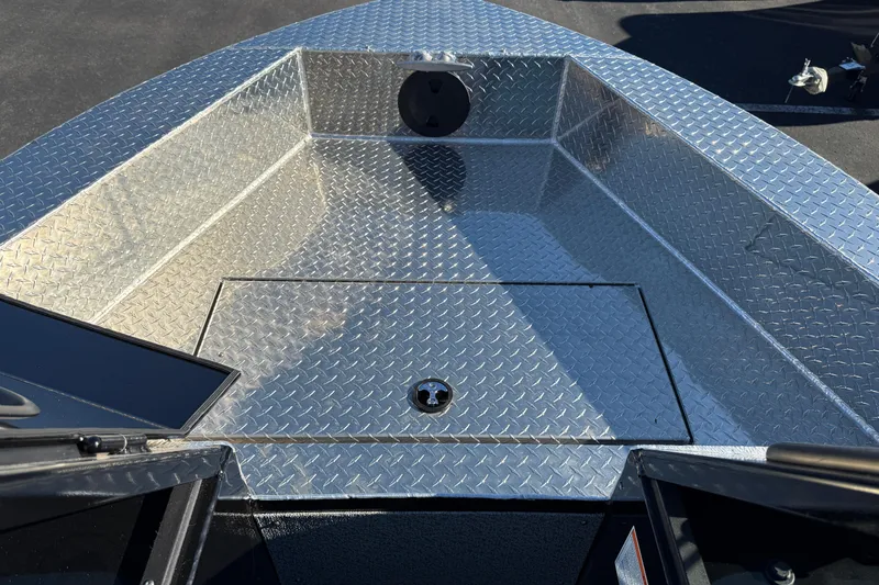 Slide: The Image of 2026 Crestliner 2050 Commander Elite boat with diamond plate flooring, open storage compartment. - 6