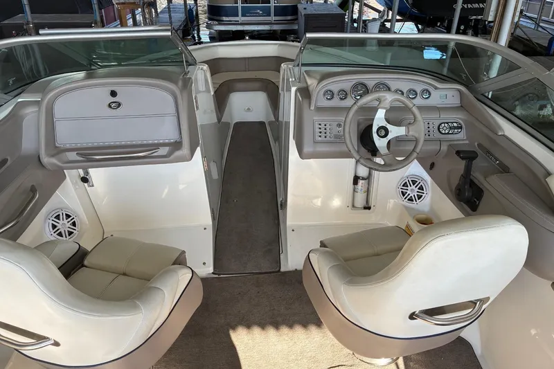 Slide: The Image of Interior of a 2000 Cobalt 246 boat with steering wheel and seating. - 10