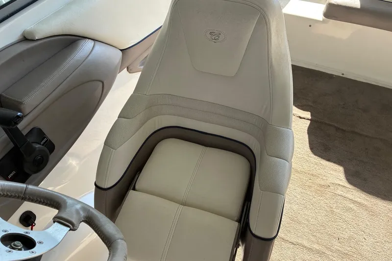 Slide: The Image of Cobalt 246 boat interior, 2000 model, featuring a beige captain's seat and steering wheel. - 4