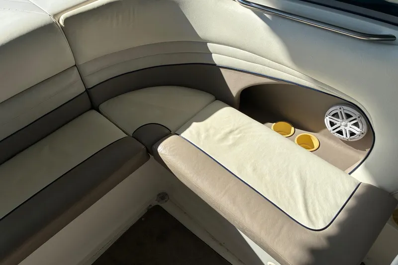 Slide: The Image of Cobalt 246 boat interior, 2000 model, featuring beige seating and cup holders. - 7