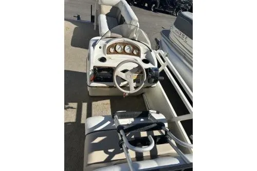 Slide: The Image of 2009 Bennington Cruise 20 boat interior with steering wheel and dashboard controls. - 2