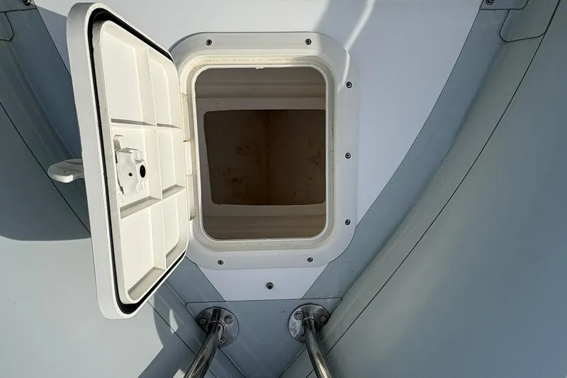Slide: The Image of Open storage compartment on 2024 Ribcraft 4.8T boat, showcasing interior space. - 13
