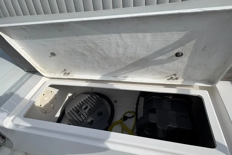 Slide: The Image of Open storage compartment in 2024 Ribcraft 4.8T boat, showing interior equipment. - 14