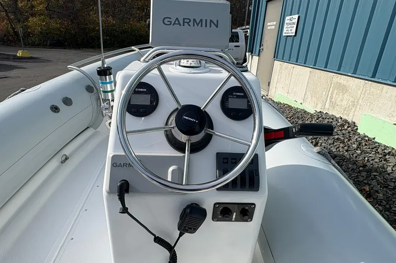 Slide: The Image of 2024 Ribcraft 4.8T boat dashboard with Garmin navigation and Yamaha controls. - 3