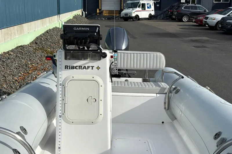 Slide: The Image of 2024 Ribcraft 4.8T boat with Garmin navigation, parked outdoors. - 9