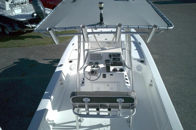 Slide: The Image of 2017 Frontier 2104 boat with T-top, steering console, and seating, viewed from above. - 11