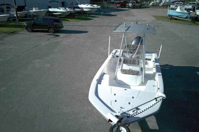 Slide: The Image of 2017 Frontier 2104 boat in a parking lot with other boats and vehicles. - 13